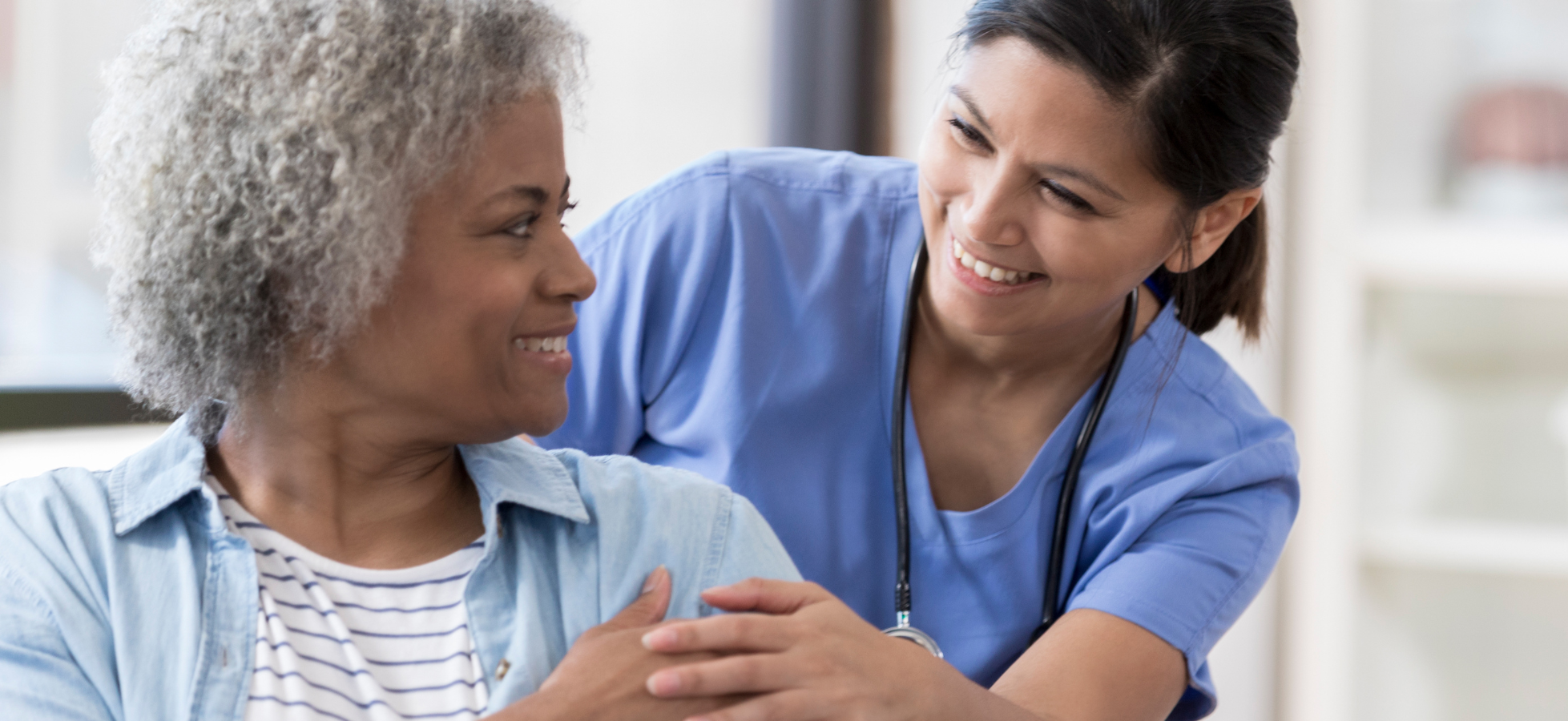 functional nurse specialist smiling while supporting a client during a consultation