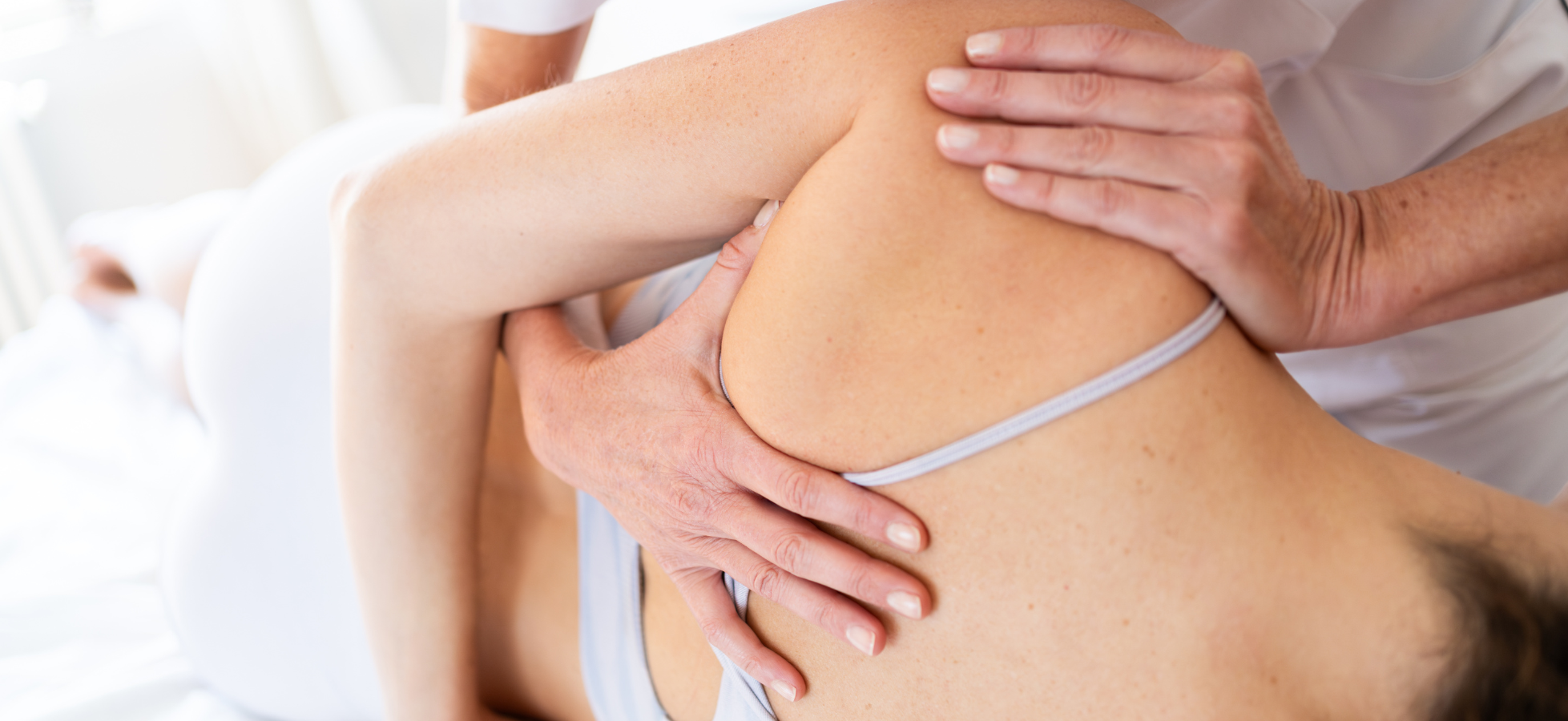 osteopath performing manual therapy on a client's upper back